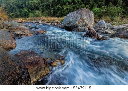 River Water Flowing Through Rocks At Dawn