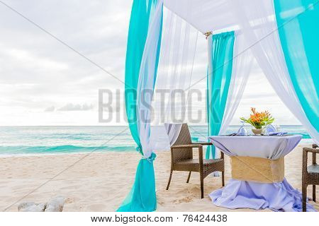 wedding arch and set up on beach, tropical outdoor wedding cabana on beach, wedding table for dinner at sunset