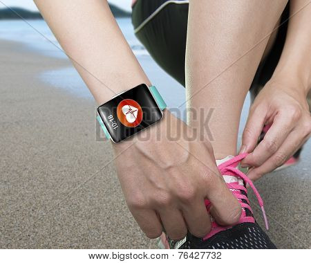 Female Hand Tying Shoelaces Wearing Bright Green Watchband Touchscreen Smartwatch