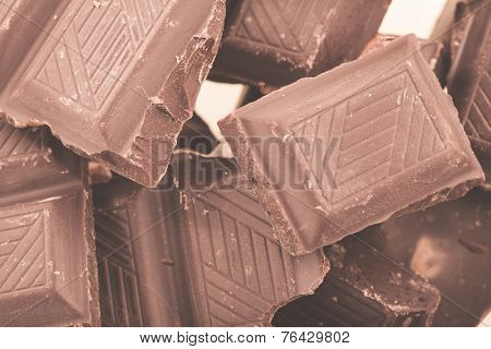 Pieces of milk chocolate closeup. Macro photo