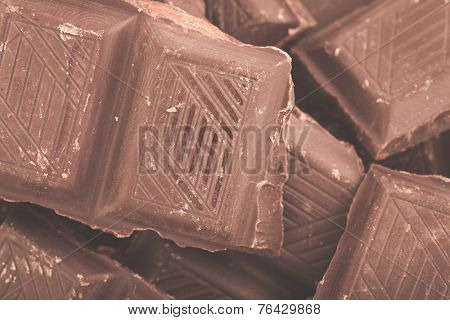 Pieces of milk chocolate closeup. Macro photo