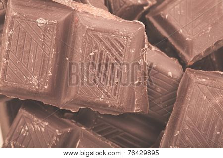 Pieces of milk chocolate closeup. Macro photo