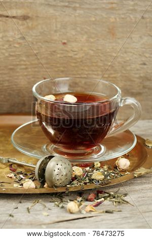 Beautiful vintage composition with herbal tea, on wooden table