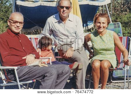 STOCKHOLM, SWEDEN, SEPTEMBER 7, 1969: Vintage photo of family with little girl outdoor