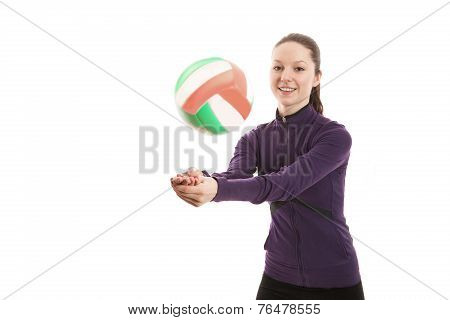 Smiling young woman playing volleyball