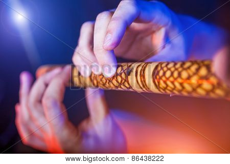Folk musician in concert plays the melody on the Ethnic Flute