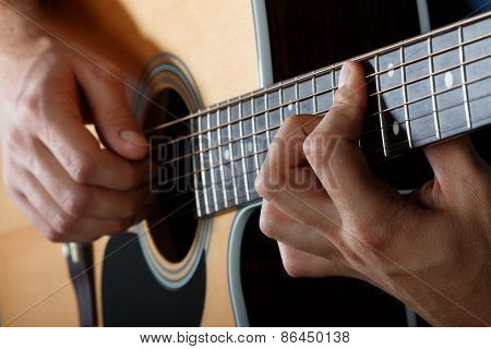 Man Performing Song On Acoustic Guitar