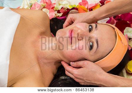 Beautician revitalizing facial.