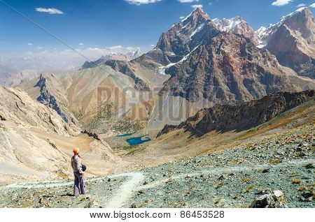 Young woman coming down the hillside to the lakes