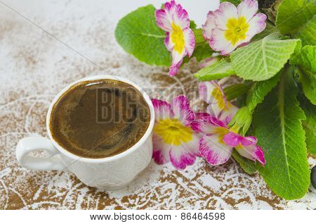Cup Of Coffee On A Table Decorated With Flowers