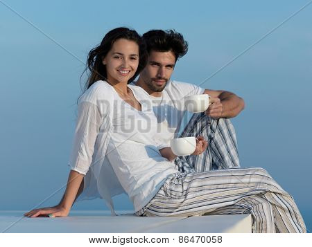 happy young romantic couple have fun relax smile at modern home outdoor terace balcony terace
