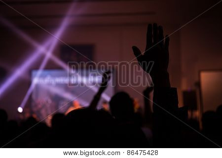 christian music concert with raised hand, live