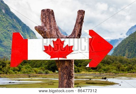 Canada wooden sign with mountains background