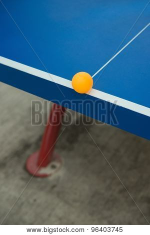 Pingpong Ball Hits The Edge Of A Blue Pingpong Table