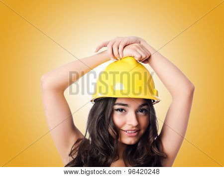 Young woman with hellow hard hat against gradient 