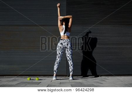 Fit female exercising on black background with copy space for your text message outdoors