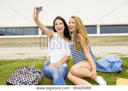 Two beautiful and happy girls making a selfie