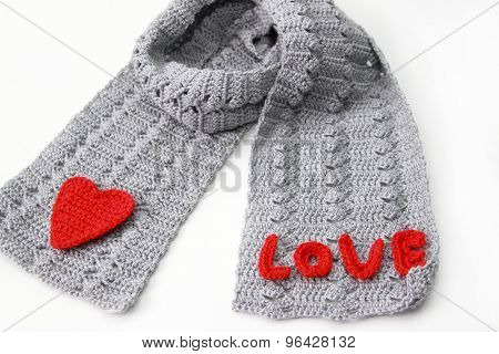 gray scarf with red crocheted heart