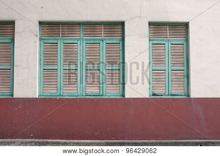Vintage green window on aged wall