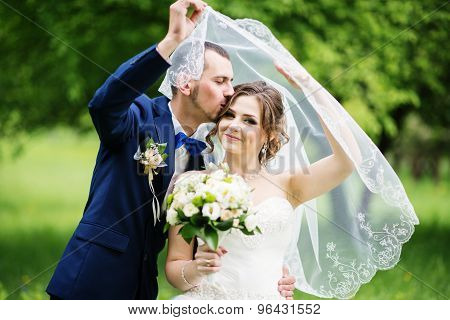 Young Lovely And Cheerfull Wedding Couple Walking At The Park