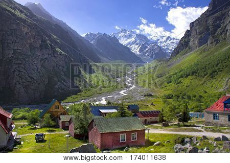 Green Valley Caucasus Mountains. The ice-capped mountains. village in the mountains.