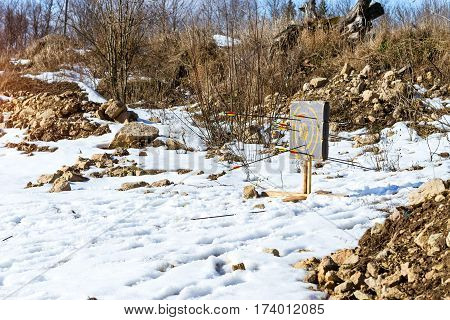 Target pierced with arrows. Homemade projectile for target shooting stands in snow. National sports entertainment outdoors. Hit target as success of business & Affairs. Funny Nicholas Fortress Russia