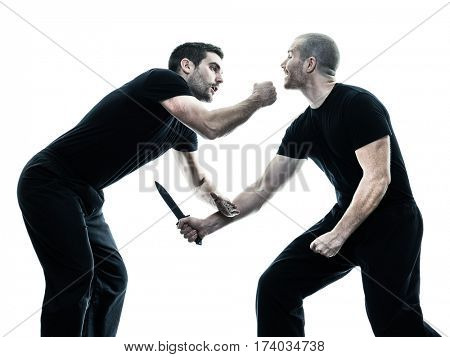 two caucasian men krav maga fighters fighting isolated silhouette on white background