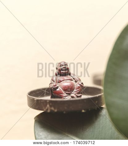 Dusty Buddha figurine decoration inside a home.