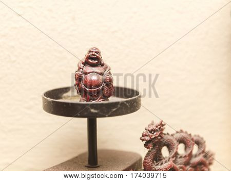 Eastern religious or traditional decorations. Buddha and dragon figurines.