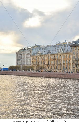 View of Neva River and Mytninskaya quay on Petrograd side in center of St.Petersburg at cloudy spring evening Russia.