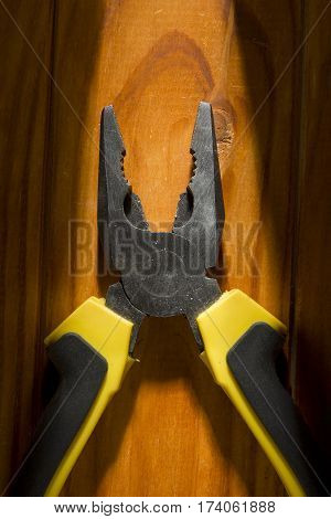 Close up of a multitool pliers on wooden background