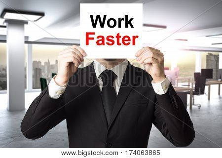 businessman in large office hiding face behind sign work faster
