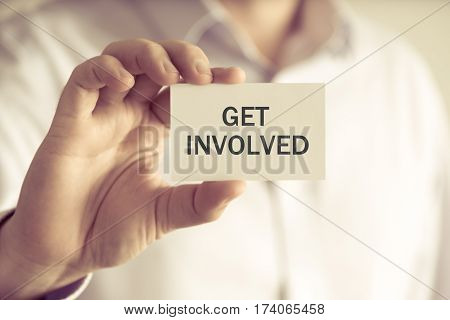 Businessman Holding Get Involved Message Card