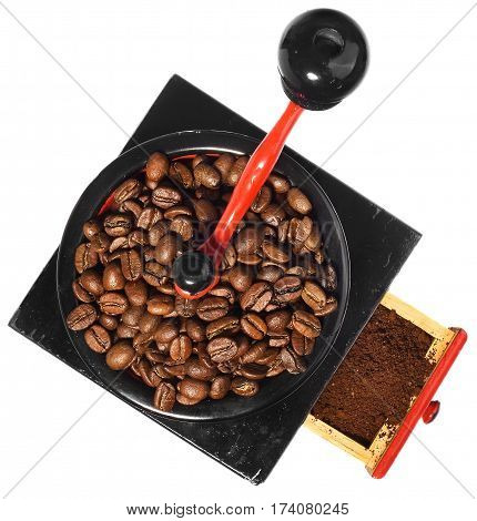 Old antique wooden coffee grinder with coffee beans and ground coffee. Coffee grinder hand-painted in black red and blue. The device isolated on a white background with light shadow and reflection.