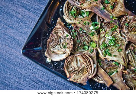 artichokes baked in oven seasoned only with olive oil parsley and lemon are a healthy and purifying food to stay fit during the summer