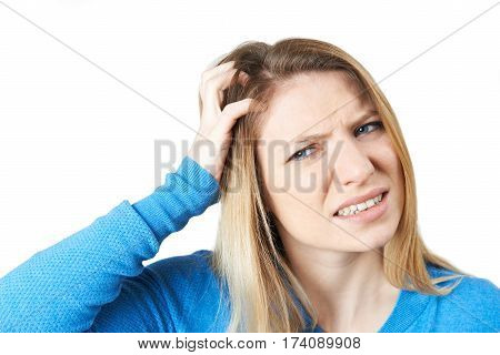 Studio Shot Of Young Woman Itching Scalp