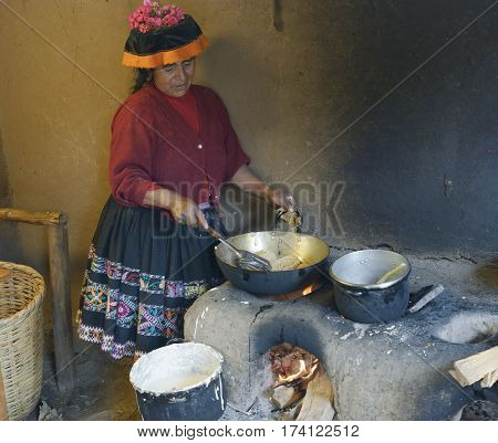 Native Peruvian woman preparing Cachangas aka fried bread on a primitive stone oven. October 22 2012 - Paru Paru Peru