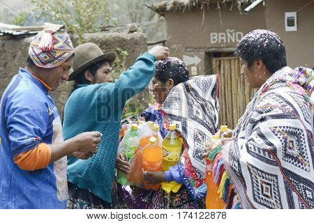 Traditional Quechua Wedding Ceremony. Indigenous woman putting confetti in the bride`s mother hair. October 22 2012 Paru Paru Peru