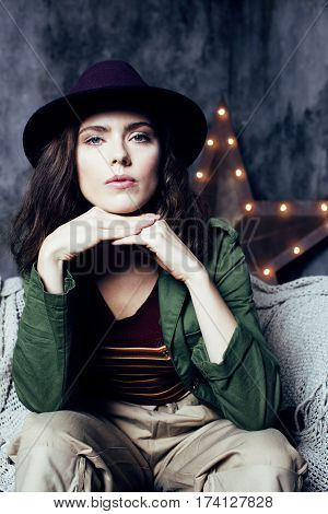 young pretty woman waiting alone in modern loft studio, fashion musician concept, lifestyle people close up