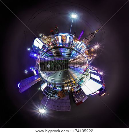 Night skyline of Warsaw with soviet era Palace of Culture and science. 360 degree panoramic montage as tiny planet