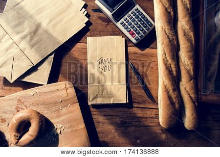 Bread and equipment of bake shop on wooden table