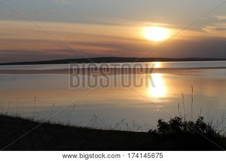 the setting sun reflected in the pond, lake, water, transparent