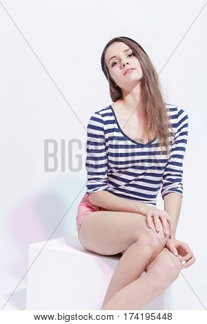 Lifestyle and Fashion Concepts. Tranquil Thinking Sensual Caucasian Brunette Girl Posing in Street Clothing Against White.Vertical Image Composition