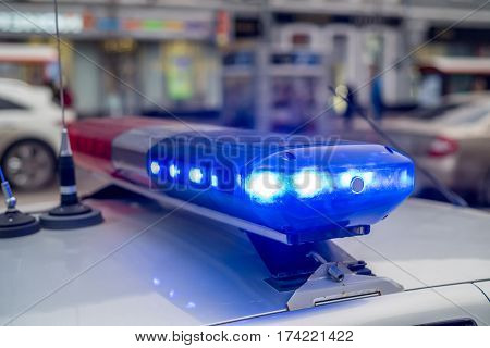 The roof-mounted activated lightbar of police vehicle