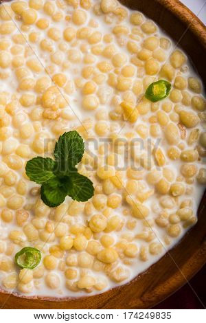 Dahi Bundi or Boondi Raita, favourite indian started or side dish made using Rajasthani snack food made from sweetened, fried chickpea flour, called Boondi with sweet and salty curd or buttermilk