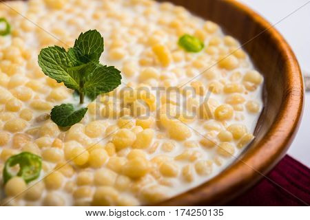 Dahi Bundi or Boondi Raita, favourite indian started or side dish made using Rajasthani snack food made from sweetened, fried chickpea flour, called Boondi with sweet and salty curd or buttermilk
