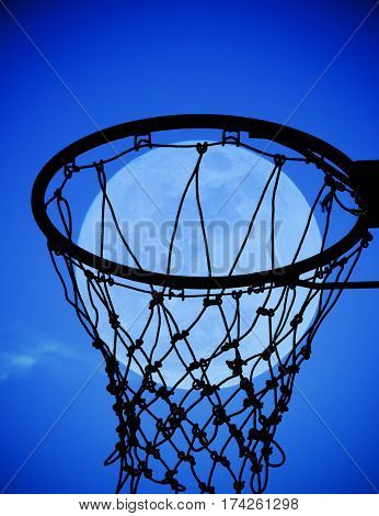 full moon in Basketball hoop at blue sky