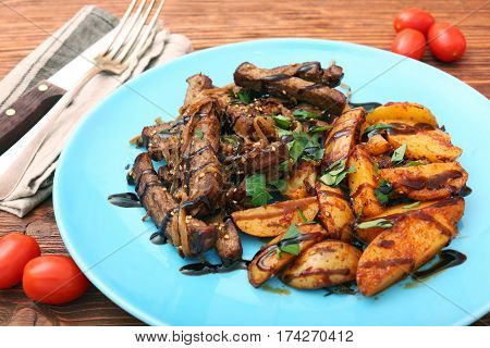 Homemade Slow Cooked Beef with Potatoes on wooden background