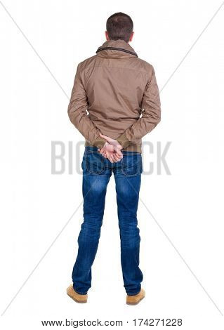 Back view of handsome man in brown windcheater looking up.   Standing young guy in jeans. Rear view people collection.  backside view of person.  Isolated over white background.