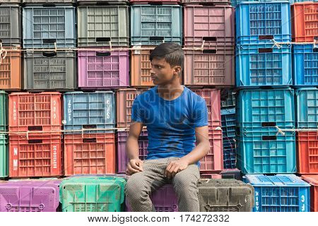 Boy Sitting On The Roadside